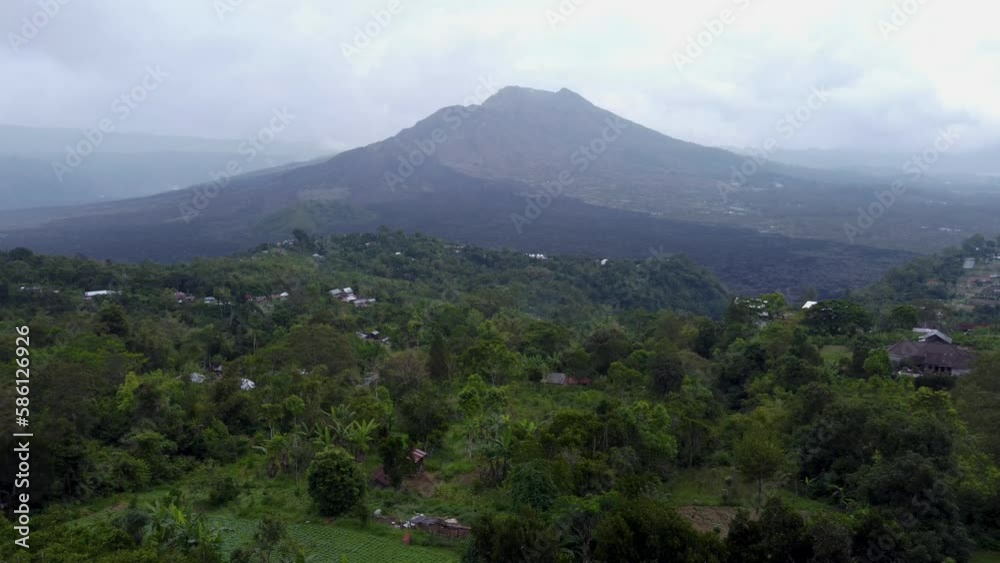 Aerial DRONE view of Mount Batur active Volcano in a rainy day in Kintamani, bali indonesia.
located in the northern tip of bali island, a famous tourist attraction as a sunrise hiking trail Aerial DRONE view of Mount Batur active Volcano in a rainy day in Kintamani, bali indonesia.
located in the northern tip of bali island, a famous tourist attraction as a sunrise hiking trail