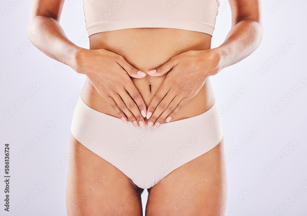 Hands, stomach and belly of a woman natural model with smooth skin isolated in a studio white background. Weight loss, diet and female touch abdomen for healthcare, fitness and nutrition