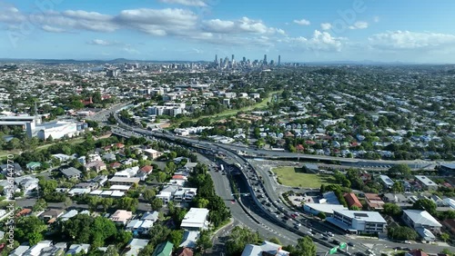 Establishing drone shot of Brisbane City, Shot above Kedron, with Gympie Road and Kedron Brook Park in frame. Camera slowly orbiting, shot in afternoon light with blue skies. photo