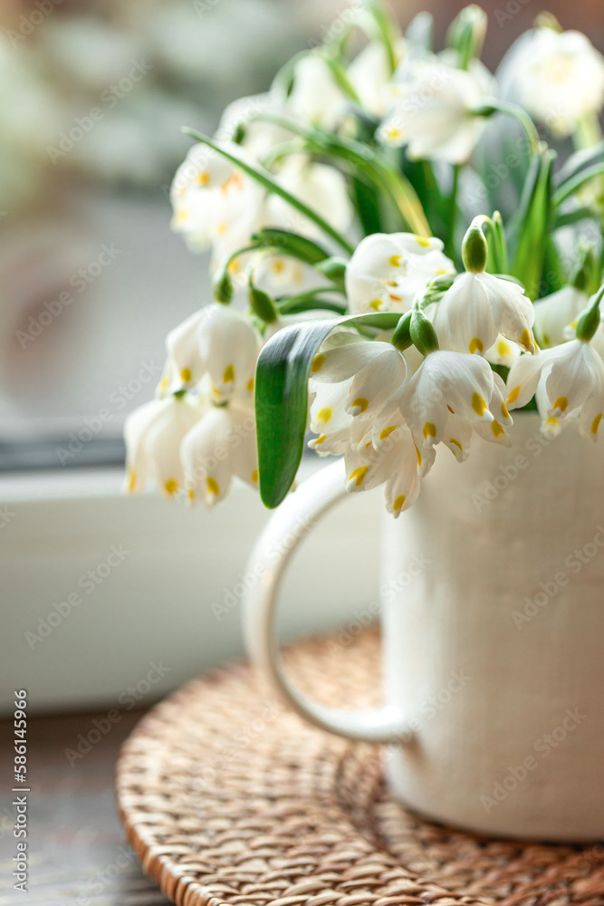 Fototapeta premium Spring composition with snowdrops in a cup, close-up.