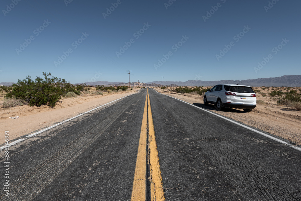 Fototapeta premium Crossing Boundless Spaces.Daytime Drive on a Long Straight Road in the USA.