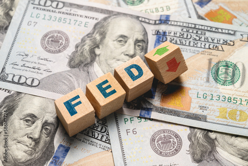 Wooden cubes with FED and up-down arrows over 100 usd. Fed rate hike concept to curb inflation