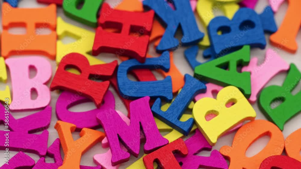 Color letters rotate in a circle. Close-up concept shot of the letters of the alphabet rotating. Alphabet, brainstorming, writing, amnesia, grammar, spelling. Color letters rotate in a circle. Close-up concept shot of the letters of the alphabet rotating. Alphabet, brainstorming, writing, amnesia, grammar, spelling.