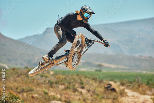 фотографія Fitness, extreme sports and mountain bike with man in nature for cycling, jump and adventure