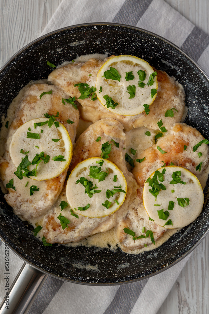 Homemade Creamy Lemon Chicken in a Pan, top view. Flat lay, overhead, from above. Homemade Creamy Lemon Chicken in a Pan, top view. Flat lay, overhead, from above.