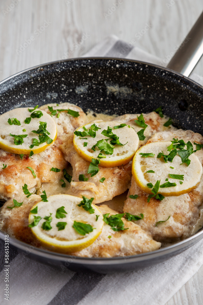 Homemade Creamy Lemon Chicken in a Pan, side view. Homemade Creamy Lemon Chicken in a Pan, side view.
