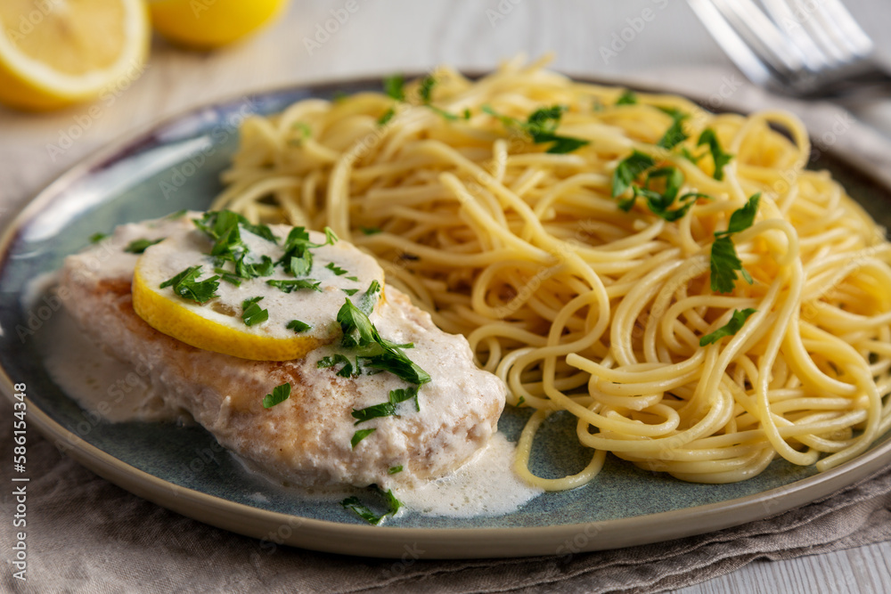 Homemade Creamy Lemon Chicken in a Pan, side view. Homemade Creamy Lemon Chicken in a Pan, side view.