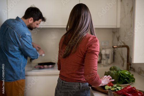 Newlyweds preparing a meal together.