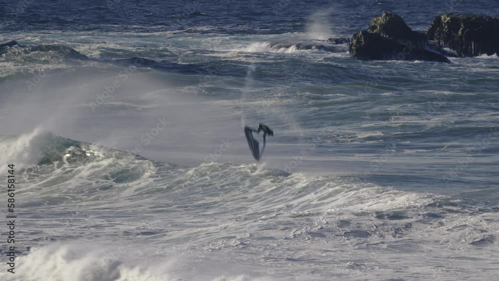 A person on a jet ski performs tricks in choppy big waves. A person on a jet ski performs tricks in choppy big waves.