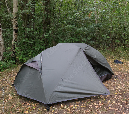 Tent pitched on a clearing in a forest