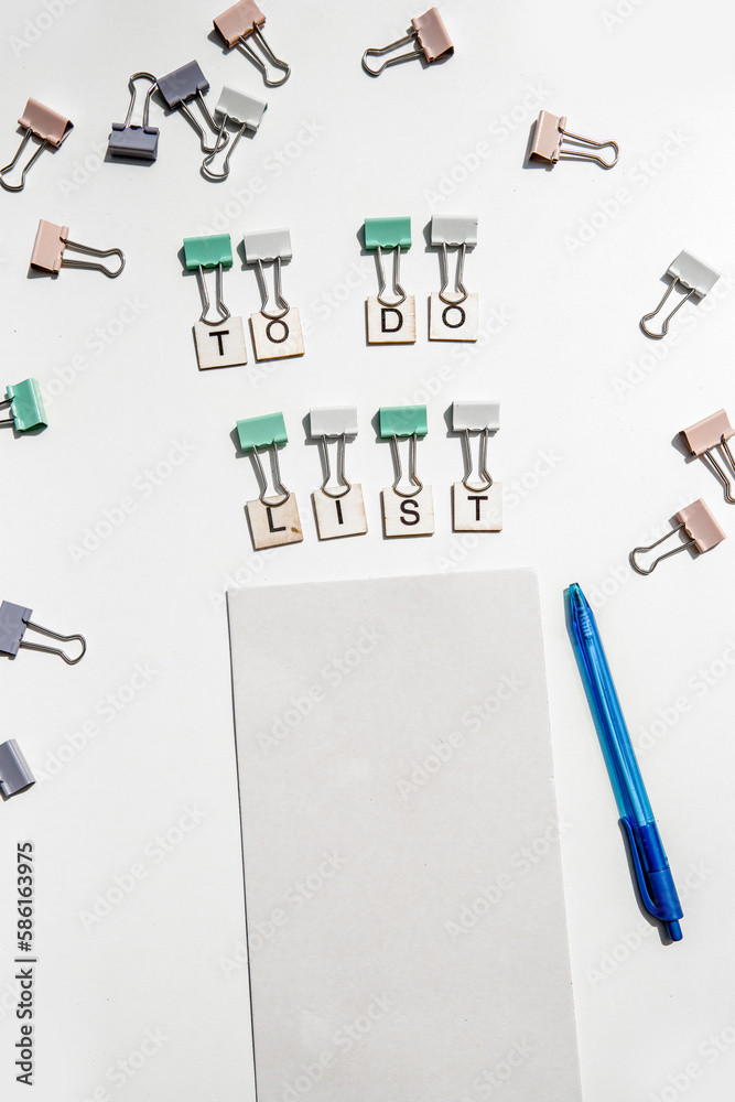 to-do list wording and metal paper clips isolated over white background, business concept, memory reminder paper, work or educational tools to-do list wording and metal paper clips isolated over white background, business concept, memory reminder paper, work or educational tools