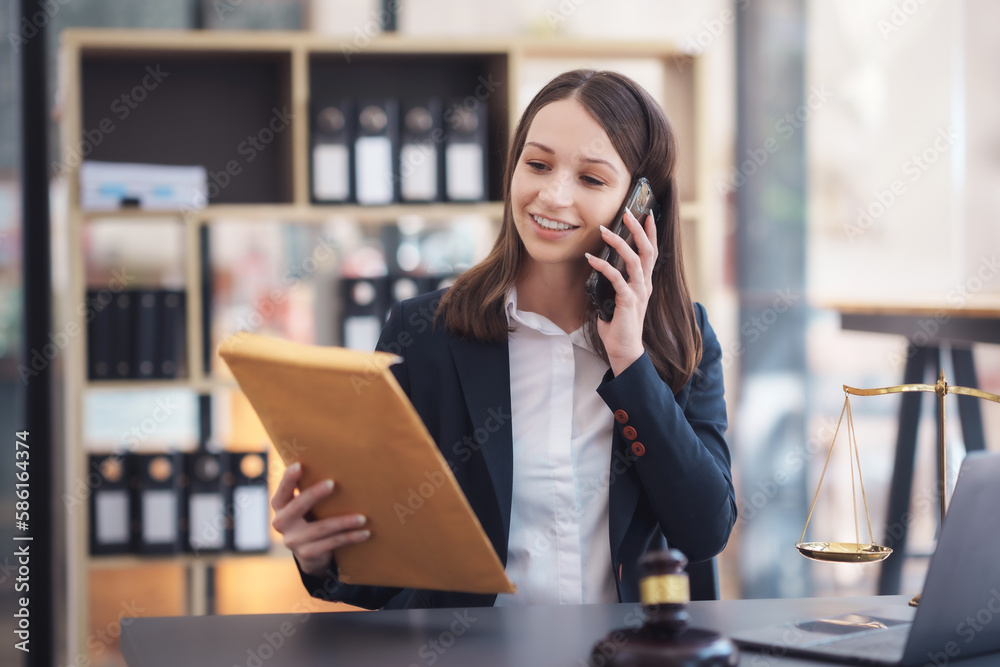 Female lawyer talking on the phone consulting with a client in a lawsuit. Female lawyer talking on the phone consulting with a client in a lawsuit.