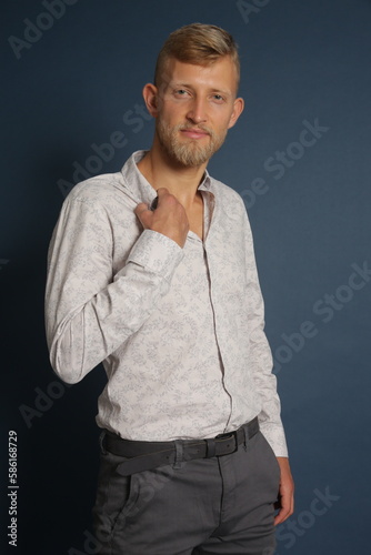 Blonde young man standing confident  portrait on studio background. Business  couch  office concept 