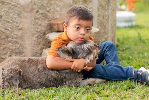 Loving bond between a boy with Down syndrome and his dog in a natural outdoor setting