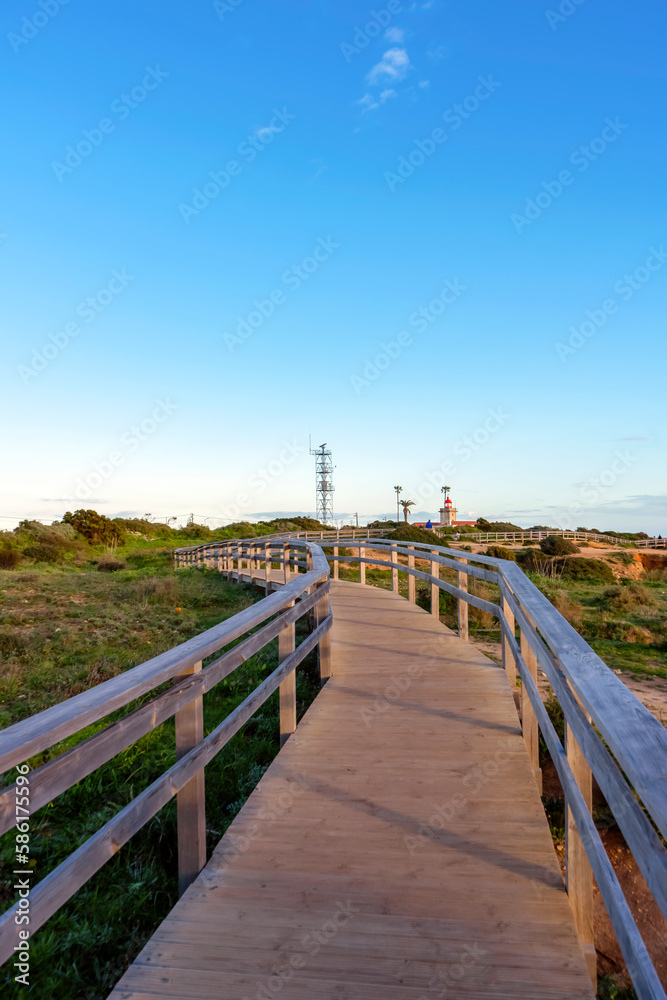 Wooden bridge to sightseeing place on Algarve coast outside Lagos, Portugal. Portuguese beaches and shores of the city of Lagos. 
