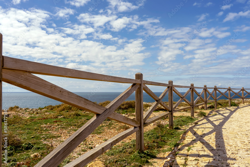 Fototapeta premium Wooden bridge to sightseeing place on Algarve coast outside Lagos, Portugal. Portuguese beaches and shores of the city of Lagos. 