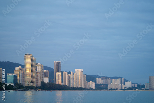Modern high rise building city scape along the seaside during sunrise.