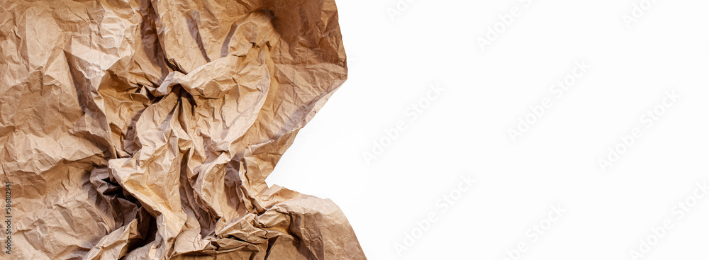 Crumpled paper of beige color isolated on white background with copy space. Panoramic banner view.