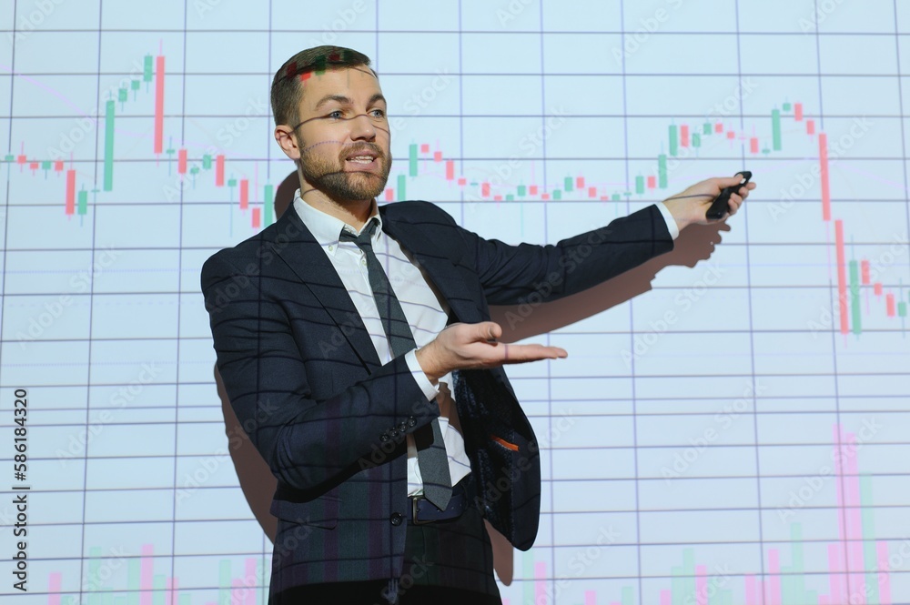 Man is standing near projector and showing graphs and business graphs. Man is standing near projector and showing graphs and business graphs.
