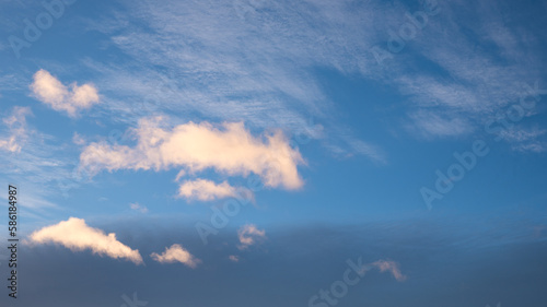 dark blue sky in the evening with lighted cumulus clouds copy space