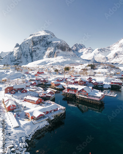 Panoramic overview of the small fishing village of A (Moskenes) at the end of the road of the Lofoten islands archipelago in northern Norway - Red rorbuer on stilts in winter at dawn in a fjord