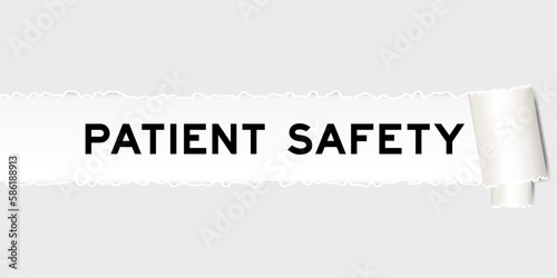 Ripped gray paper background that have word patient safety under torn part