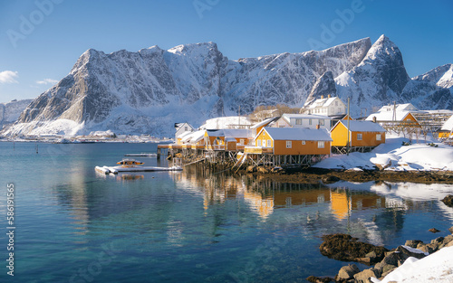 Beautiful view of scenic Lofoten Islands archipelago winter scenery with traditional yellow fisherman Rorbuer cabins in the historic village of Sakrisoy at sunrise  Norway  Scandinavia
