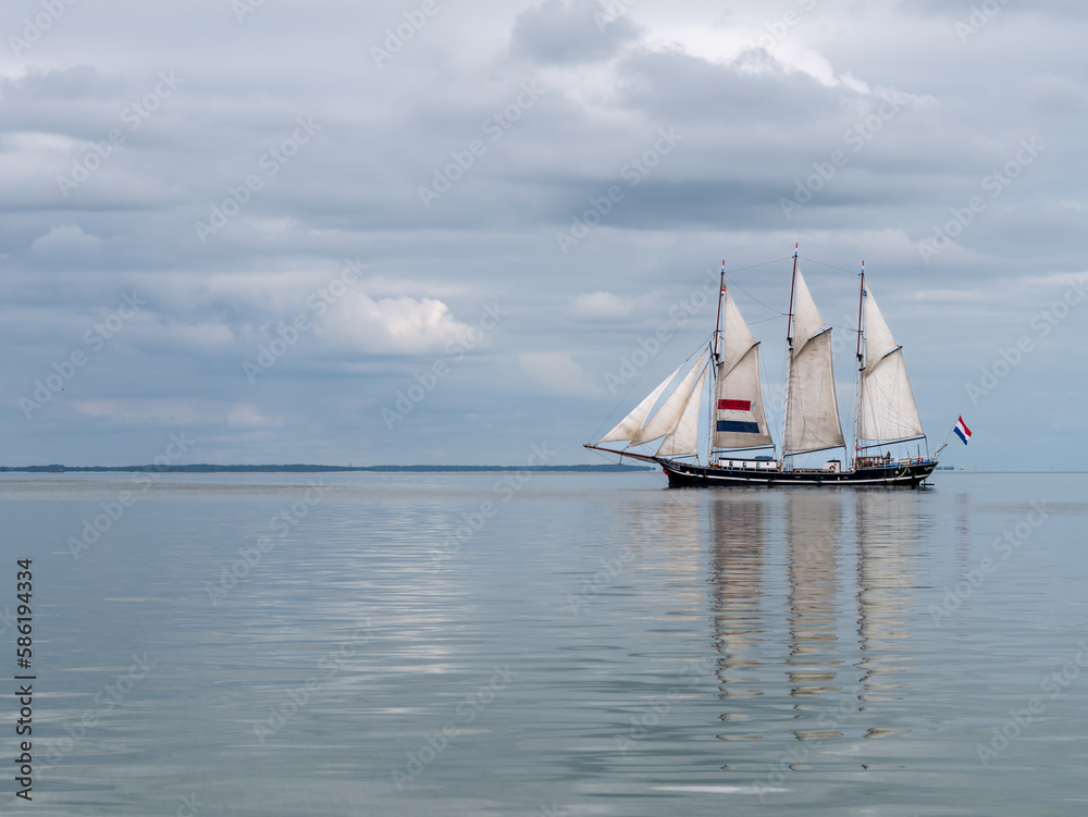 Obraz premium Traditional three-mast clipper sailing on IJsselmeer lake, Netherlands