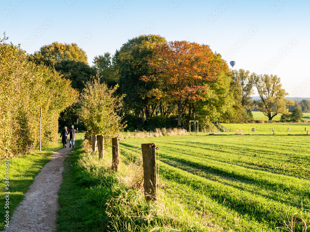 Naklejka premium Walkers on footpath through nature near town of Ootmarsum, Overijssel, Netherlands