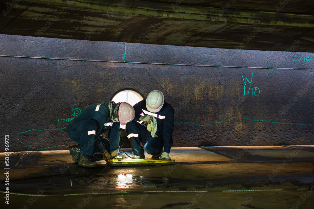 Male worker inspection vacuum test bottom plate tank petrochemical steel weld leak Male worker inspection vacuum test bottom plate tank petrochemical steel weld leak
