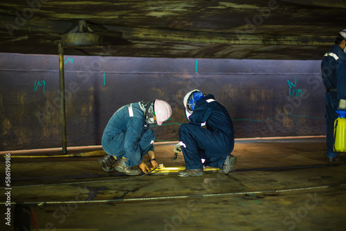 Male worker inspection vacuum test bottom plate tank petrochemical steel weld leak