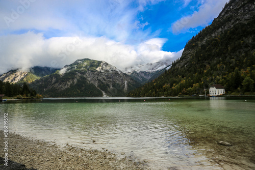 Fall at lake Plansee with turquoise water in recreational silence