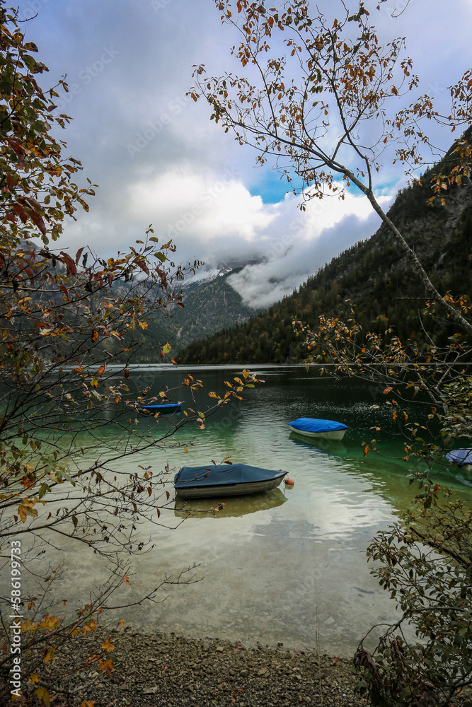 Fall at lake Plansee with turquoise water in recreational silence

