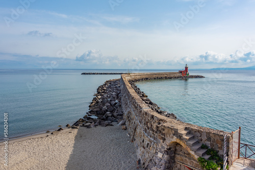 Breakwater at Porto d'Ischia town at Ischia island, Italy photo