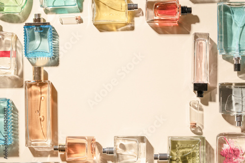 Frame copyspace, for the sale of cosmetics, perfume advertising layout beige background concept layout. Transparent perfume bottles framing.