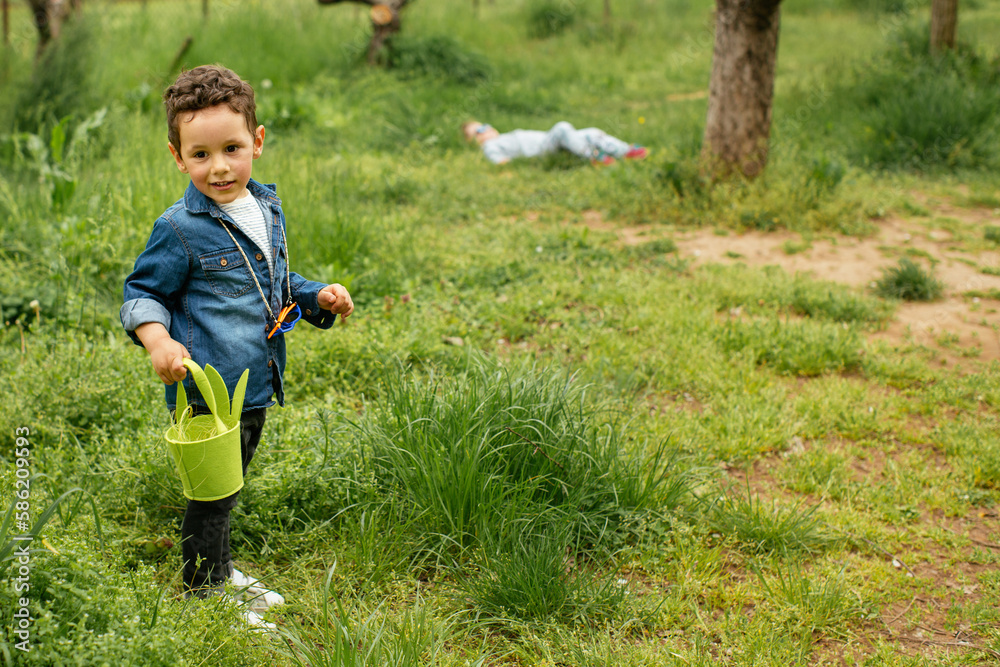 Fototapeta premium Boy in Easter hunt , holding basket 