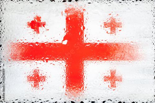 Georgia flag. Flag of Georgia on the background of water drops. Flag with raindrops. Splashes on glass