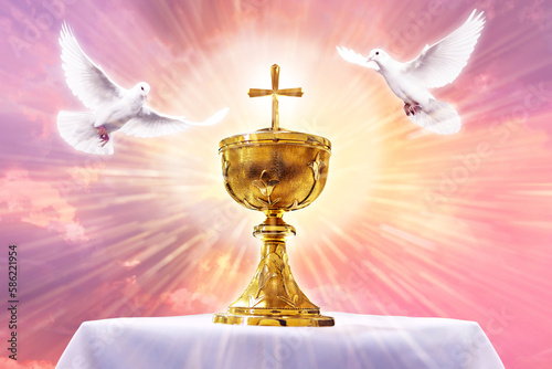 Chalice with crucifix in an altar with flying doves. Holy eucharist theme concept. photo