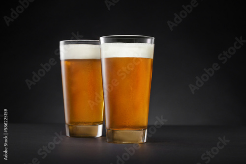 Glass with beer on a dark background. Pint of beer, craft beer