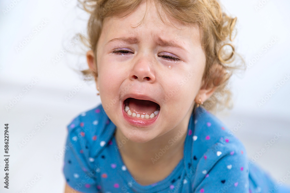 Child crying tears face girl. Selective focus. Child crying tears face girl. Selective focus.
