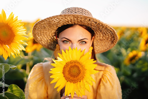 Funny woman in retro dress in sunflowers field. Yellow colors, warm toning.