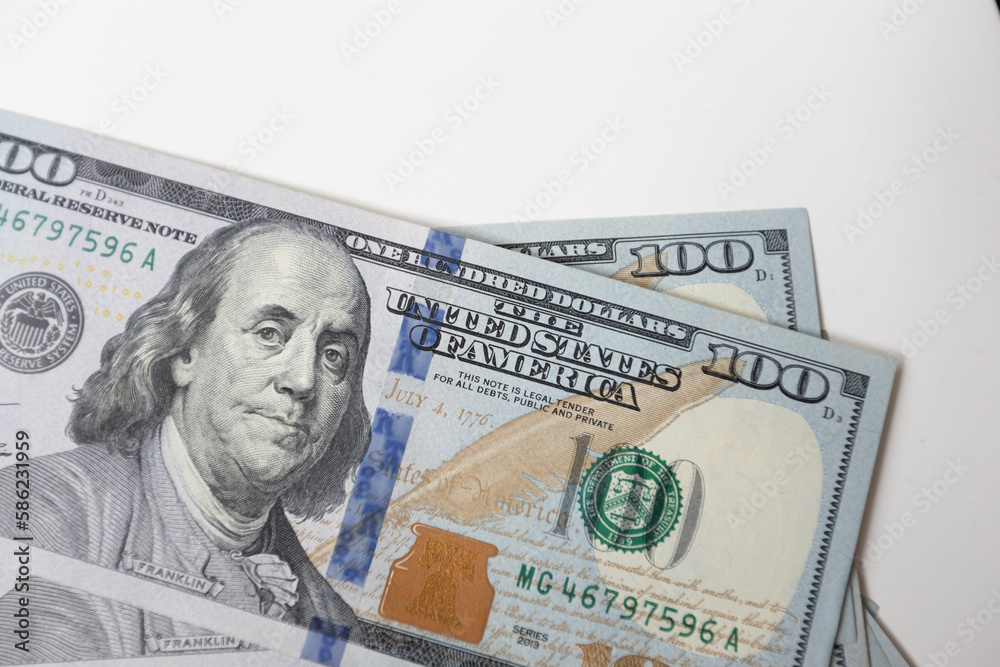 A closeup of a hundred dollar bill featuring Benjamin Franklin, the iconic symbol of American