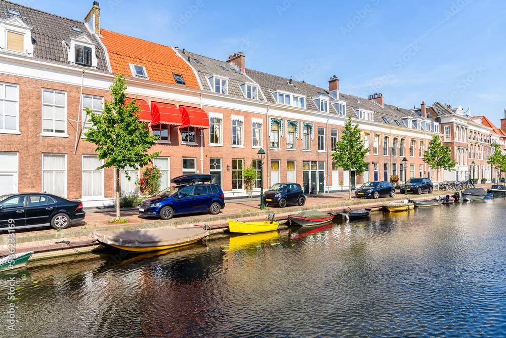 Row of brick houses along a canal on a sunny summer day