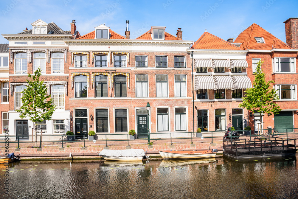 Renovated row houses along a canal on a clear summer day