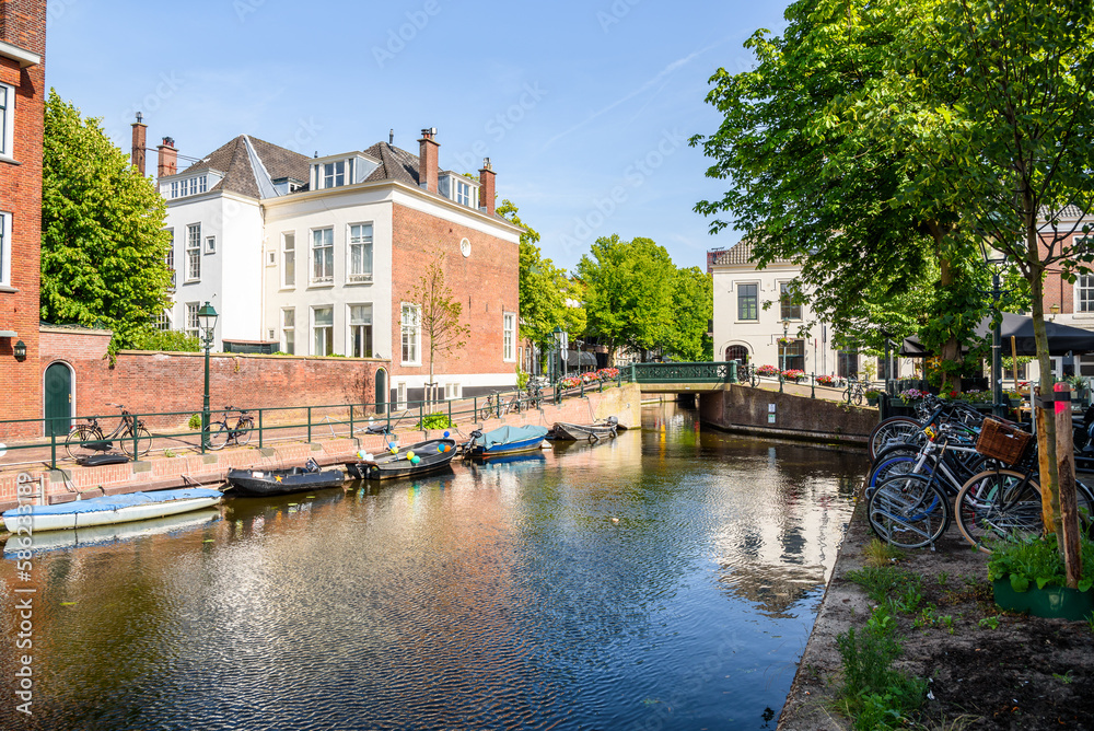 Canal lined with residential and commercial buildings in The Hague city centre on a sunny summer day
