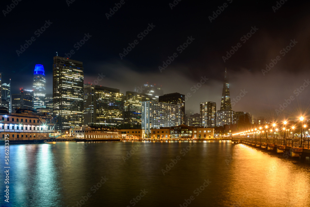 San Francisco downtown skyline partly covered with fog at night in autumn