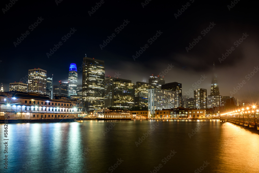 San Francisco financial district skyline as seen from pier seven on a foggy autumn night