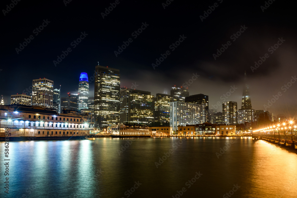 San Francisco financial district skyline as seen from pier seven on a foggy autumn night San Francisco financial district skyline as seen from pier seven on a foggy autumn night