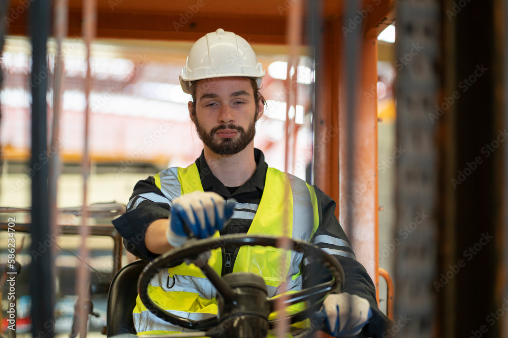 Foto de Male worker driving a forklift while falling asleep. dangerous
