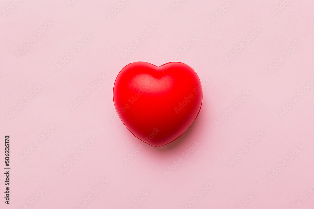 red heart shape on colored background. minimal concept top view with copy space